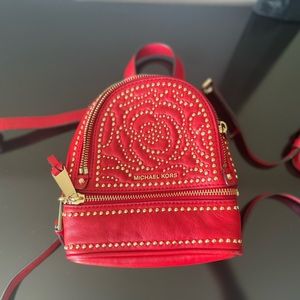 MICHEAL KORS mini backpack in red with gold accents
